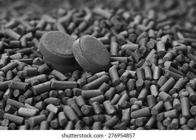 Activated carbon granules and tablets close up