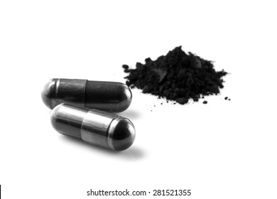 Activated charcoal capsule and powder isolated on white