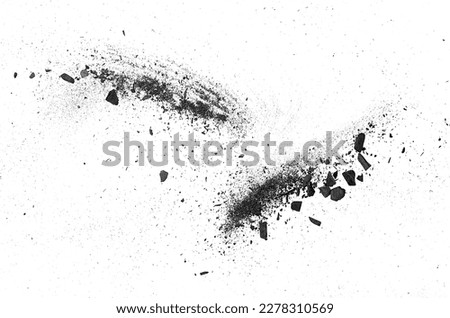 Activated charcoal powder on a white background, top view. Black coal powder. Scattered charcoal dust.
