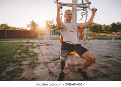 Active amputee training using exercising machine in outdoor gym - Powered by Shutterstock