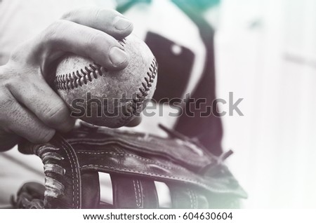 Active athlete with old rough baseball and vintage mitt.  Great sport equipment or fitness and exercise background