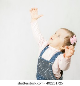 Active Baby Pulls Her Hands Up. Jumping, Playing. Happy Child. Wish