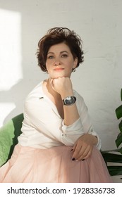 The An Active, Beautiful Middle-aged Woman. Close-up Of A Woman's Face With A Smile. Mature Healthy Woman For Advertising Sitting In A Chair