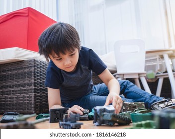 Active boy crawling on floor playing with soldiers and tank toys in playroom, Happy Kid playing wars and peace on his own, Child stay at home relaxing on weekend, Children imagination and development