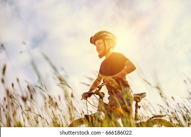 Active boy rides a bicycle