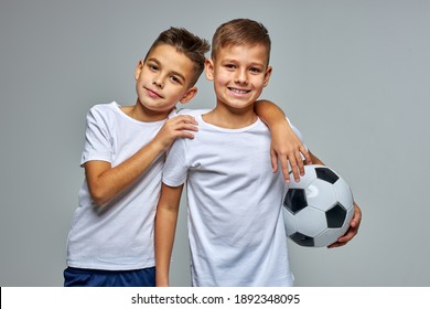 Active Boys With Soccer Ball In Hands, Young Caucasian Teenagers Posing, Hugging Each Other, Engaged In Sport, Play In The Same Team