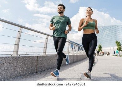 Active couple running together in the city, embodying teamwork and the joy of shared fitness pursuits. - Powered by Shutterstock