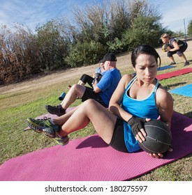 Active diverse group in boot camp fitness class on mats - Powered by Shutterstock