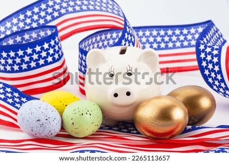 Active, diversified American savings are successful signified by white piggy bank placed with gold nest eggs and diversified, assorted colored eggs 