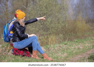 Active elderly Caucasian couple hiking with backpacks  enjoying their adventure. They sit with their backs to the camera. - Powered by Shutterstock