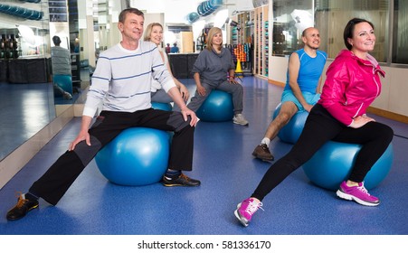 Active Elderly Exercise With Gymnastic Balls In Modern Gym