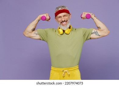 Active Elderly Gray-haired Bearded Man 40s Years Old In Headband Khaki T-shirt Exercise With Dumbbells Isolated Plain Pastel Light Purple Background Studio Portrait. Workout Sport Lifestyle Concept