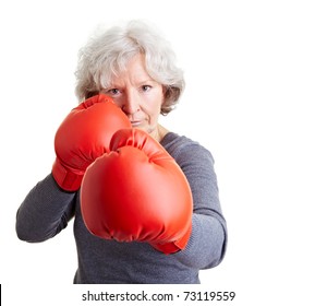 Active elderly woman fighting with red boxing gloves - Powered by Shutterstock