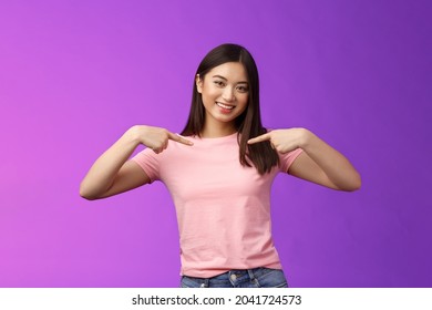 Active energized friendly tender asian stylish girl introduce herself, pointing chest proudly, smiling boastful, describe own achievements, bragging accomplishments, stand pleased purple background - Shutterstock ID 2041724573