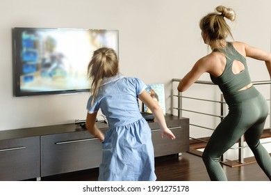 Active Family Dancing With Modern Video Game Console At Home