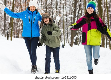 Active Family - Mother And Kids Running, Jumping In Winter Park