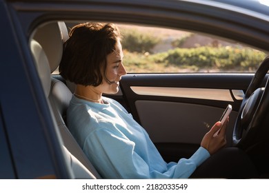 Active female traveler using her digital map while travelling by car - Shutterstock ID 2182033549