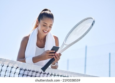 Active, fit and happy female tennis player browsing social media on her phone outdoors on the court. A young female athlete or sportswoman posting her sport training online or on the internet - Powered by Shutterstock