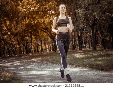 Similar – Fit healthy athletic woman jogging on a river bank