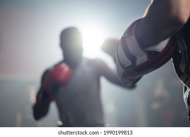 Active Fitness trainer teach and motivate young African american sportsman workout, exercising doing boxing or Muay Thai. Boxer Athlete fighter wearing glove, practicing punching to coach at gym club. - Powered by Shutterstock