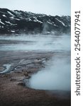 Active geyser park in Iceland. Column of hot water and steam in the air