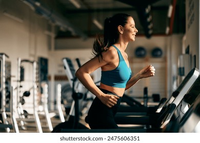 An active girl running on a treadmill at the gym, doing cardio training. - Powered by Shutterstock