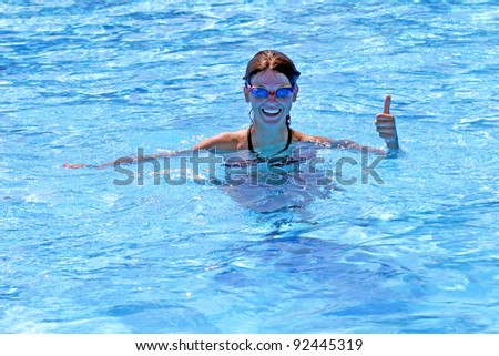 Active girl swimming in swimming pool