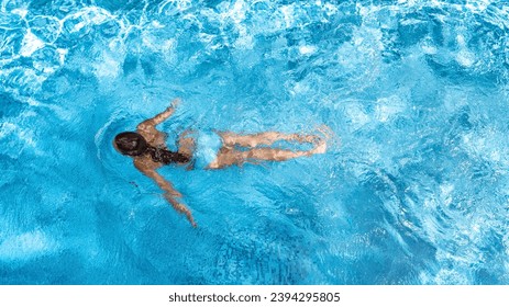 Active girl in swimming pool aerial drone view from above, young woman swims in blue water, tropical vacation, holiday on resort concept - Powered by Shutterstock