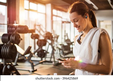 Active Girl Using Smartphone In Fitness Gym.