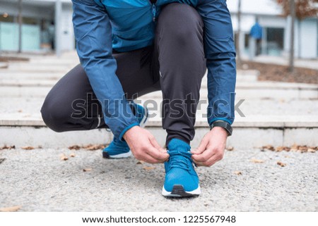 Active guy preparing for a running session
