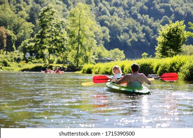 Active happy family kayaking on the river. Father and daughter having fun enjoying adventurous experience canoeing on a sunny day trip during summer vacation. Adult and children doing sport together. - Powered by Shutterstock