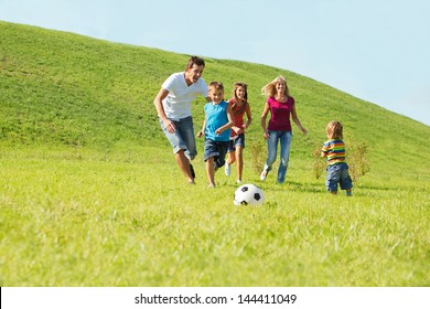 Active Happy Family Playing With A Ball