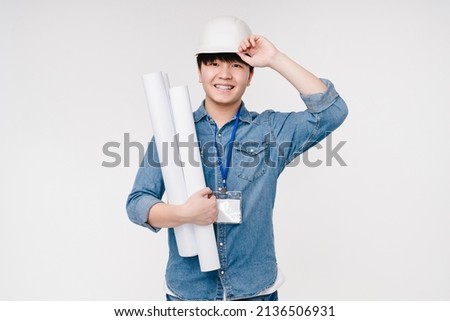 Active happy smiling asian korean young male man architect construction worker in white hardhat holding architectural plans on building isolated in white background