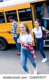 Active Happy Teen Scholars Running Out School Bus 