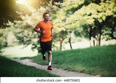 Active healthy runner jogging outdoor - Shutterstock ID 648750601