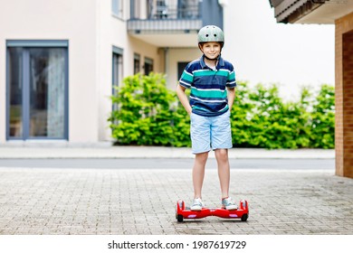 Active Kid Boy On Hover Board. Child Driving Modern Balance Hoverboard. Excercise And Sports For Children, Outdoor Activity For Young Kids.