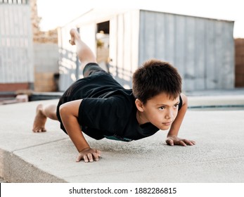 Active kid doing exersises in the backyard, childhood and healthy life concept - Image