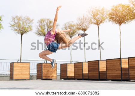 Similar – Unrecognizable women jumping over garden fence background