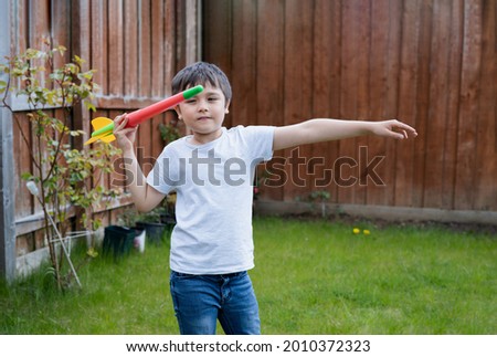 Active kid preparing to throwing a Javelin, Healhty Child practicing athletics throw Javelin. Outdoor activity for Children on Spring or Summer