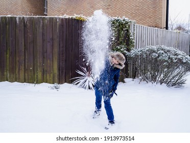 Active Kid Throwing Snowball On The Road, Happy Boy Playing Snow Fight Outdoor In The Winter. Funny Child Throwing Snow At Camera.