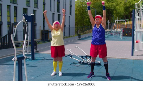 Active leisure of senior team doing fitness exercising on playground. Outdoors portrait of elderly grandmother and grandfather pensioners family engaged in sports doing stretching cardio. Motivation - Powered by Shutterstock