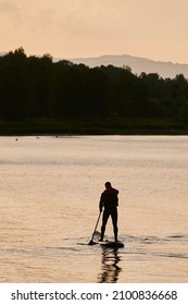 Active Leisure In Summer Lifestyle. A Boy Rides On The Sea In A Sap. Concept Of Solitude, Outdoor Recreation, Hygge.