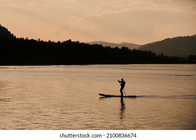 Active Leisure In Summer Lifestyle. A Boy Rides On The Sea In A Sap. Concept Of Solitude, Outdoor Recreation, Hygge.