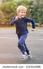 active lifestyle in a modern city - little happy boy runs through the stadium