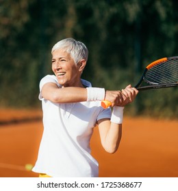 Active Lifestyle Seniors – Positive Mature Woman Playing Tennis Recreationally - Powered by Shutterstock