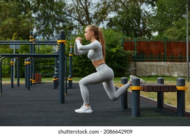 Active Lifestyle. Slim Blond Woman Working Out In Outdoor Gym At Summer Warm Day.