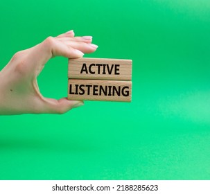 Active Listening Symbol. Wooden Blocks With Words Active Listening. Beautiful Green Background. Businessman Hand. Business And Active Listening Concept. Copy Space.