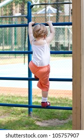 Active Little Child Climbing On A Ladder Outdoors