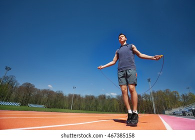 Active Male Athlete Skipping The Rope Outside