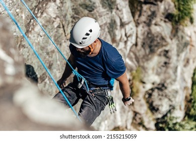 Active Man With A Climbing Hamlet On Going Down After Reaching The Top.